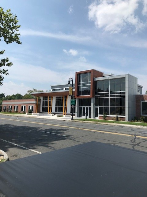 Glass-and-brick building exterior viewed across a street.